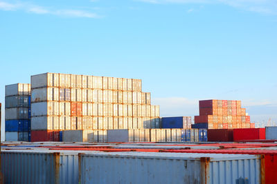 Stack of building by pier against sky