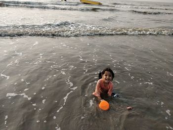 High angle portrait of boy swimming in sea