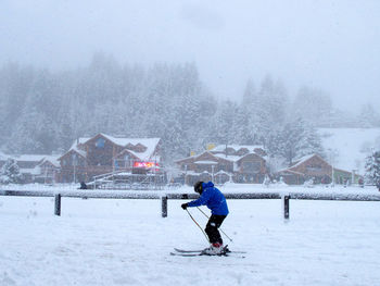 Full length of man skiing on snow covered field