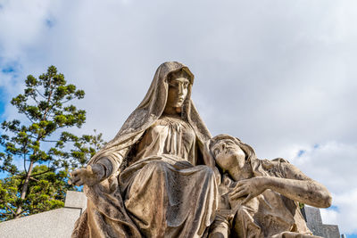 Low angle view of statue against sky