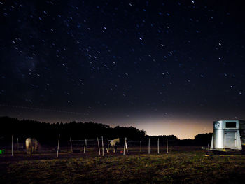 Scenic view of field against sky at night