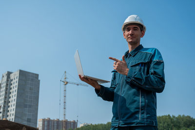 Portrait of man standing against sky