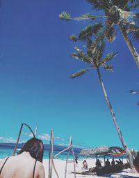 Woman at beach against sky