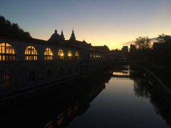 View of bridge over river at sunset