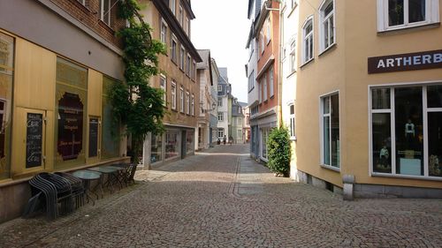 Empty alley amidst buildings in town