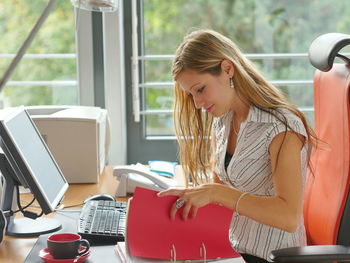 Young woman using laptop at office