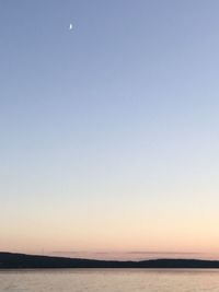 Scenic view of sea against clear sky at sunset