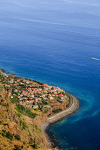 High angle view of sea and buildings in vilage