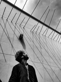 Portrait of man wearing sunglasses standing against sky