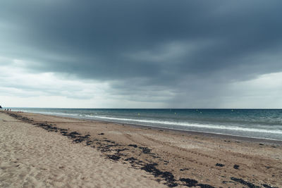 Beach with dark clouds and incoming rain storm. vacation with bad weather concept