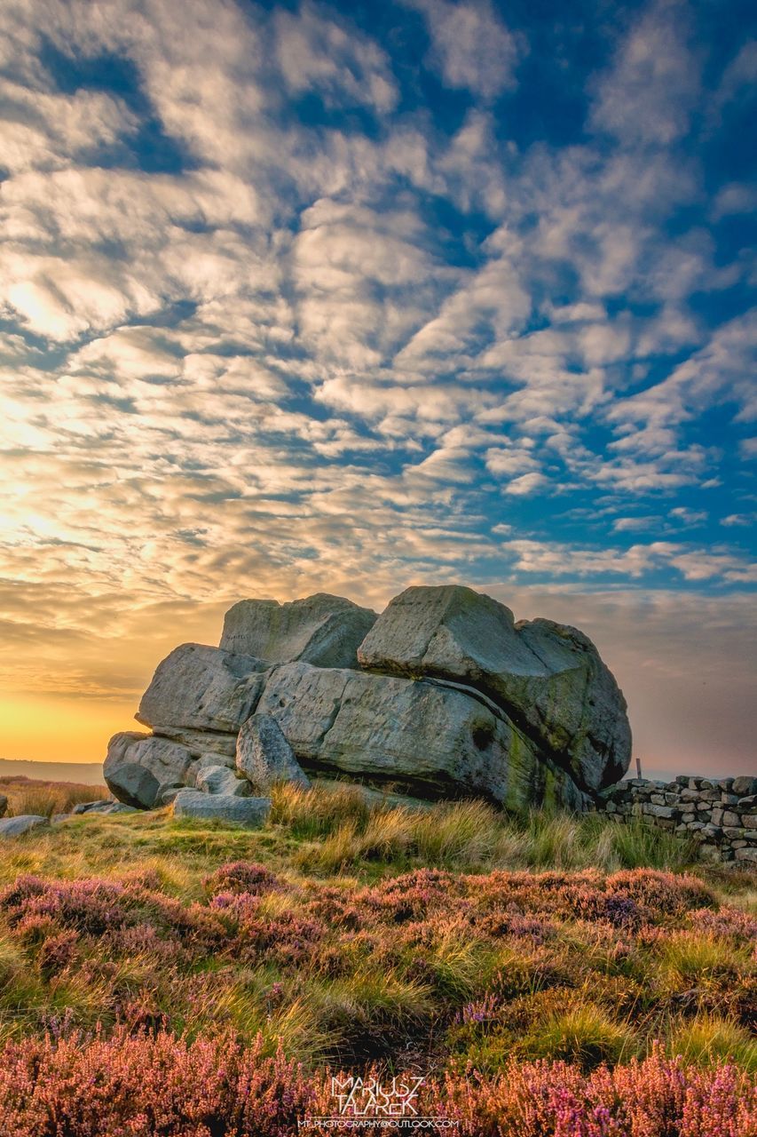 sky, grass, tranquility, tranquil scene, cloud - sky, landscape, scenics, beauty in nature, nature, field, rock - object, cloud, non-urban scene, cloudy, remote, outdoors, idyllic, rock formation, grassy, no people