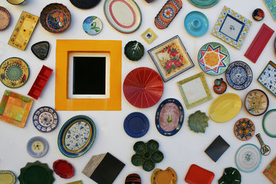 Directly above shot of multi colored crockery on table