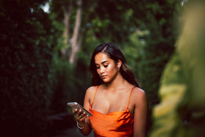 Portrait of beautiful young woman using mobile phone.