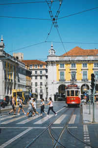 People on street in city against clear sky