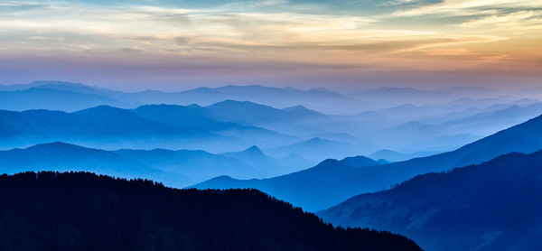 Scenic view of mountains against sky at sunset