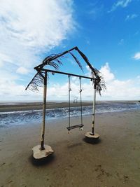 Lifeguard hut on beach against sky