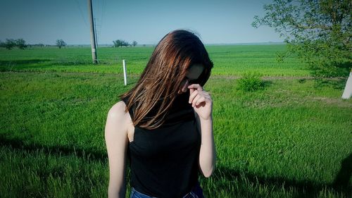 Midsection of woman standing on field