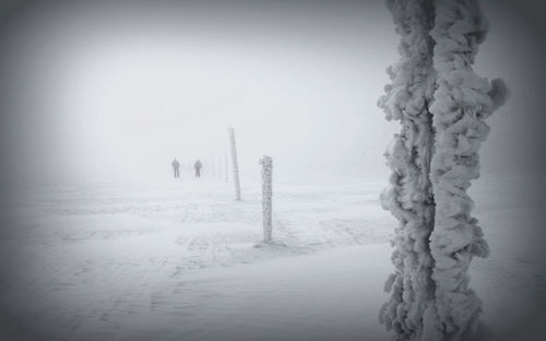 Snow covered landscape against clear sky