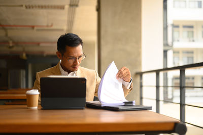 Young woman using laptop at table
