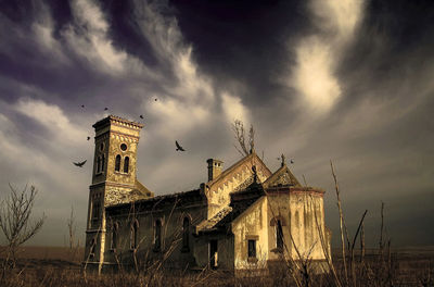 Old church on field against sky