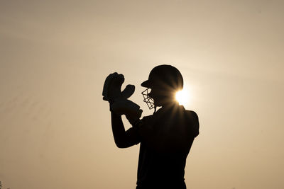 Silhouette woman against sky during sunset