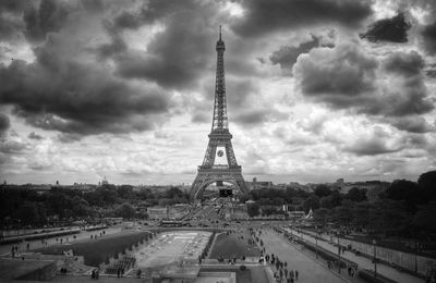 Eiffel tower against cloudy sky