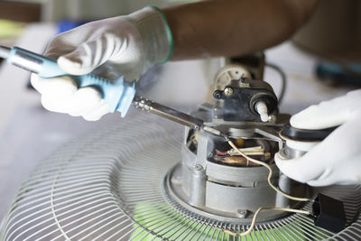 Close-up of man working in machine