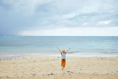 Man surfing in sea against sky