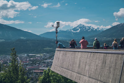 People looking at view of cityscape against sky