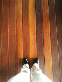 Low section of people standing on wooden floor