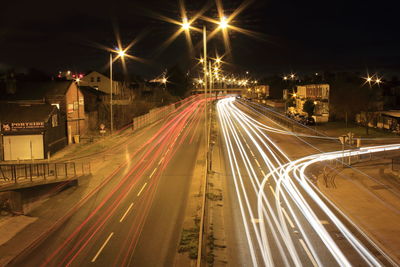 High angle view of light trails on road at night