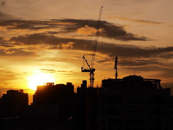 Silhouette of buildings against sky during sunset