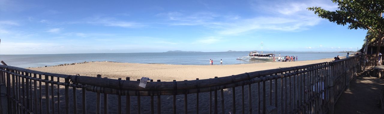 sea, beach, horizon over water, water, sky, shore, sand, scenics, tranquil scene, beauty in nature, tranquility, nature, incidental people, vacations, railing, cloud - sky, pier, idyllic, tourism, panoramic