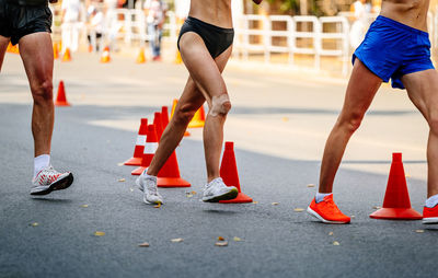 Low section of people walking on road