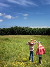 People walking on grassy field