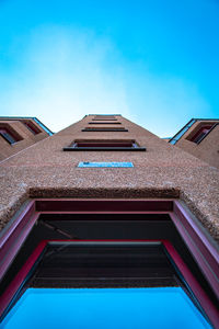 Low angle view of building against blue sky