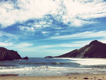 Scenic view of sea against cloudy sky