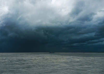 Scenic view of sea against storm clouds