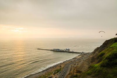 High angle view of street by sea against sky during sunset