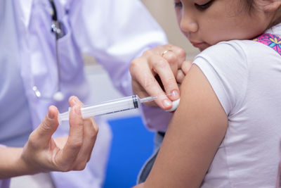 Midsection of doctor examining patient