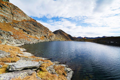 Scenic view of lake and mountains against sky