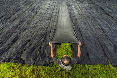 Rear view of man standing on field