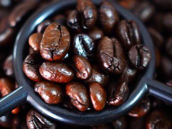 High angle view of roasted coffee beans in container