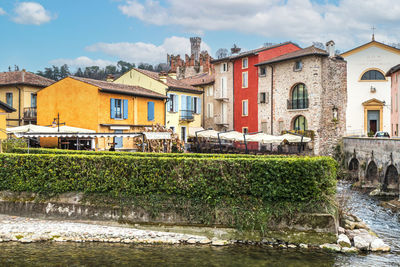 The beautiful colored houses of the hamlet of borghetto sul mincio reflecting on the water