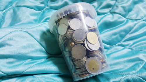 High angle view of coins on bed