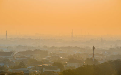 High angle view of buildings in city during sunset