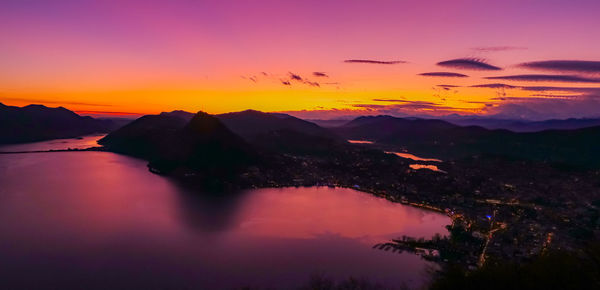 Scenic view of mountains against dramatic sky during sunset