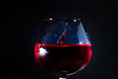 Close-up of red wine against black background