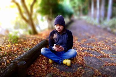 Portrait of man sitting in autumn