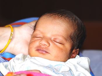 Close-up of baby boy sleeping on bed
